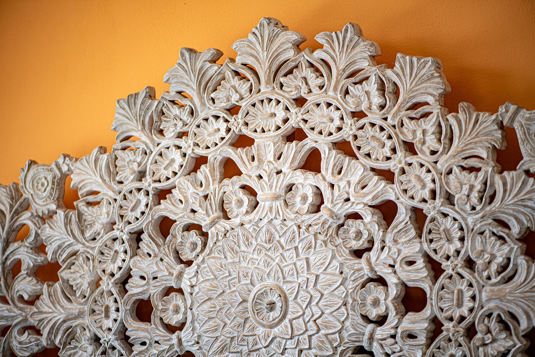 Carved mandala headboard detail