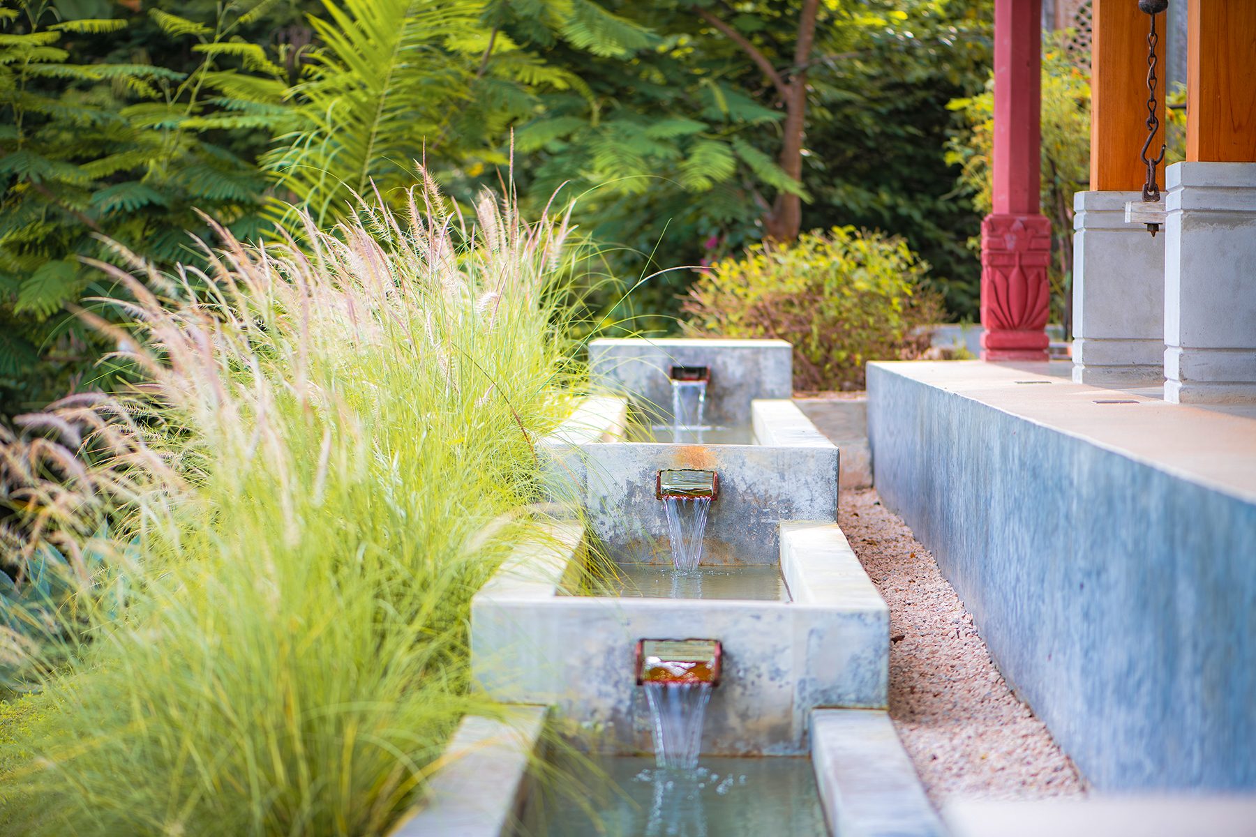 Tiered stone water fountain running beside the veranda at The Sanctuary Estate, Nosara, Costa Rica